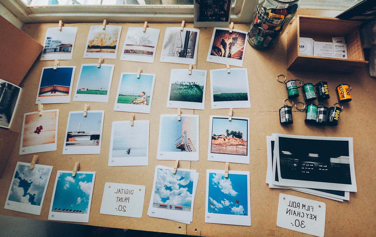 polaroid assorted photos on beige wooden table decoration