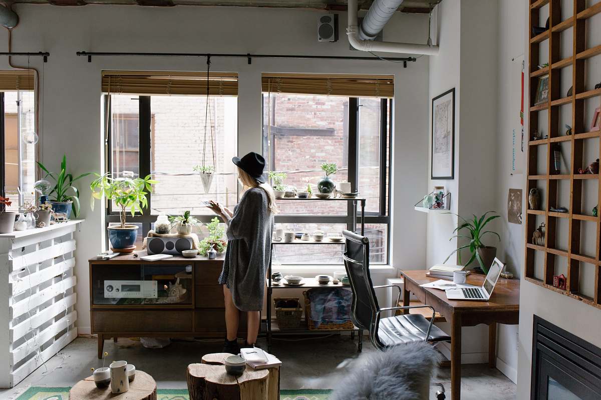 home woman standing near brown wooden cabinet interior