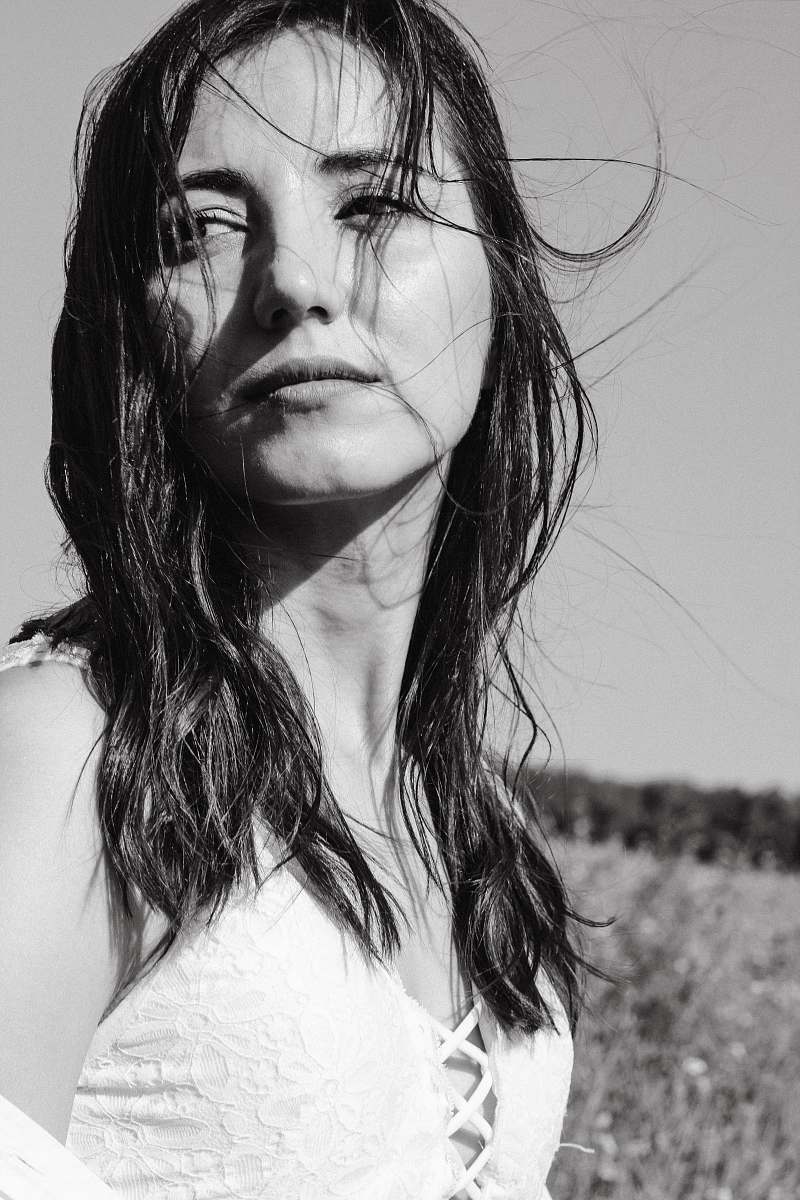 black-and-white grayscale photography of woman standing and facing her right side face