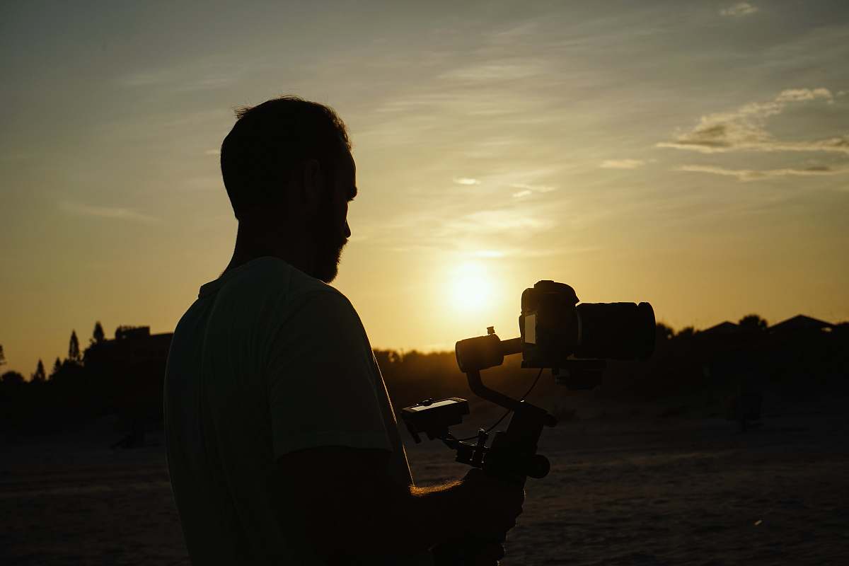 human man holding camera light