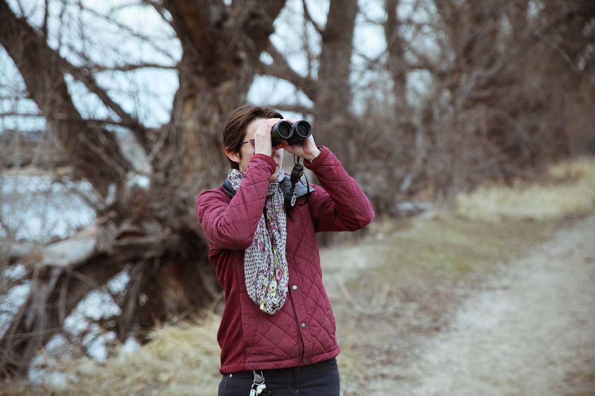 human man using binoculars bluff lake natural area