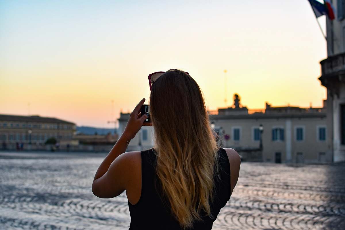 human woman holding camera during daytime photo