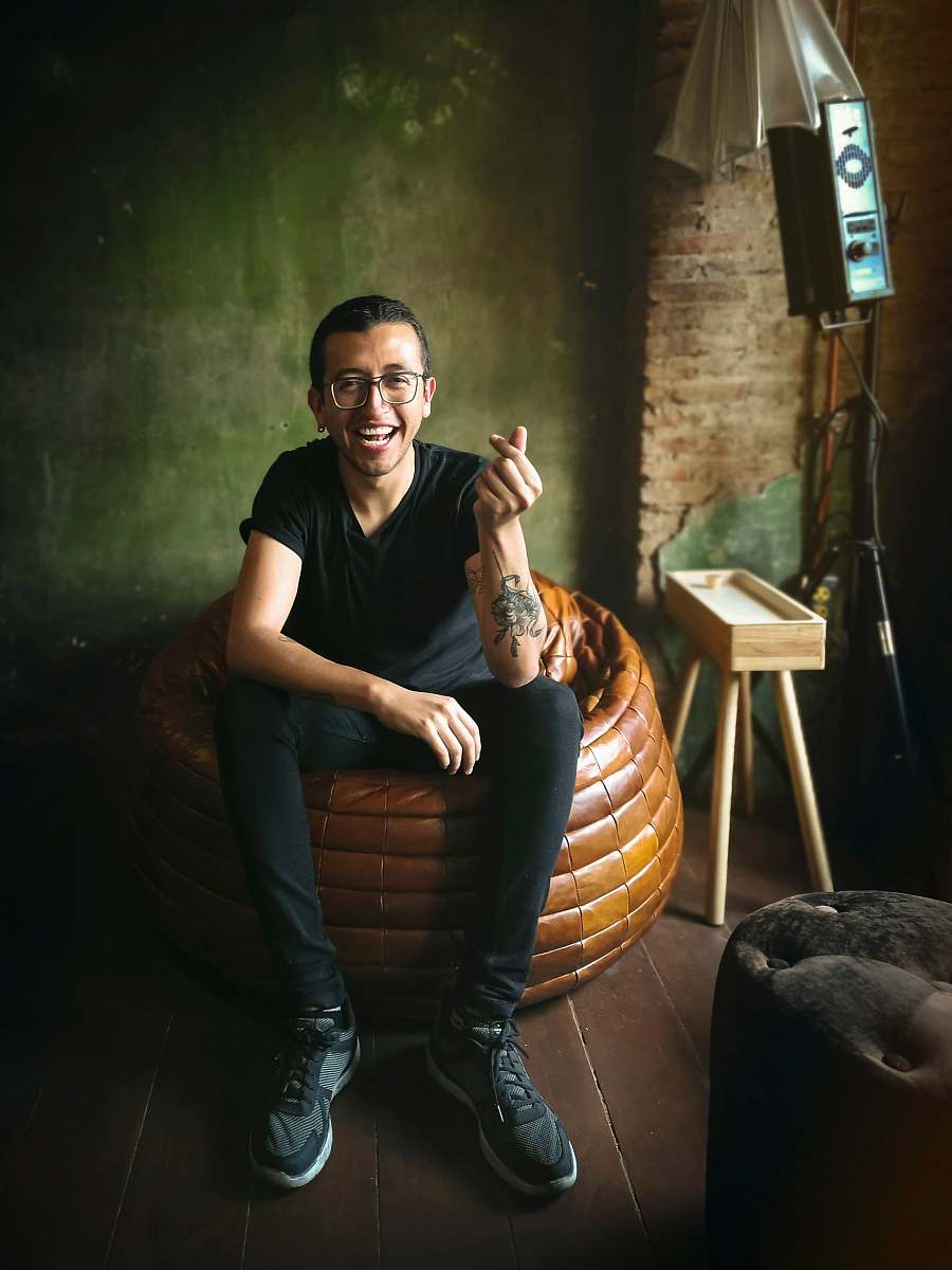 person unknown person sitting on brown chair indoors footwear
