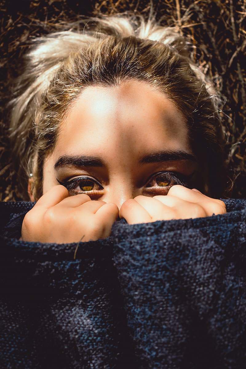 person woman covering her face half people