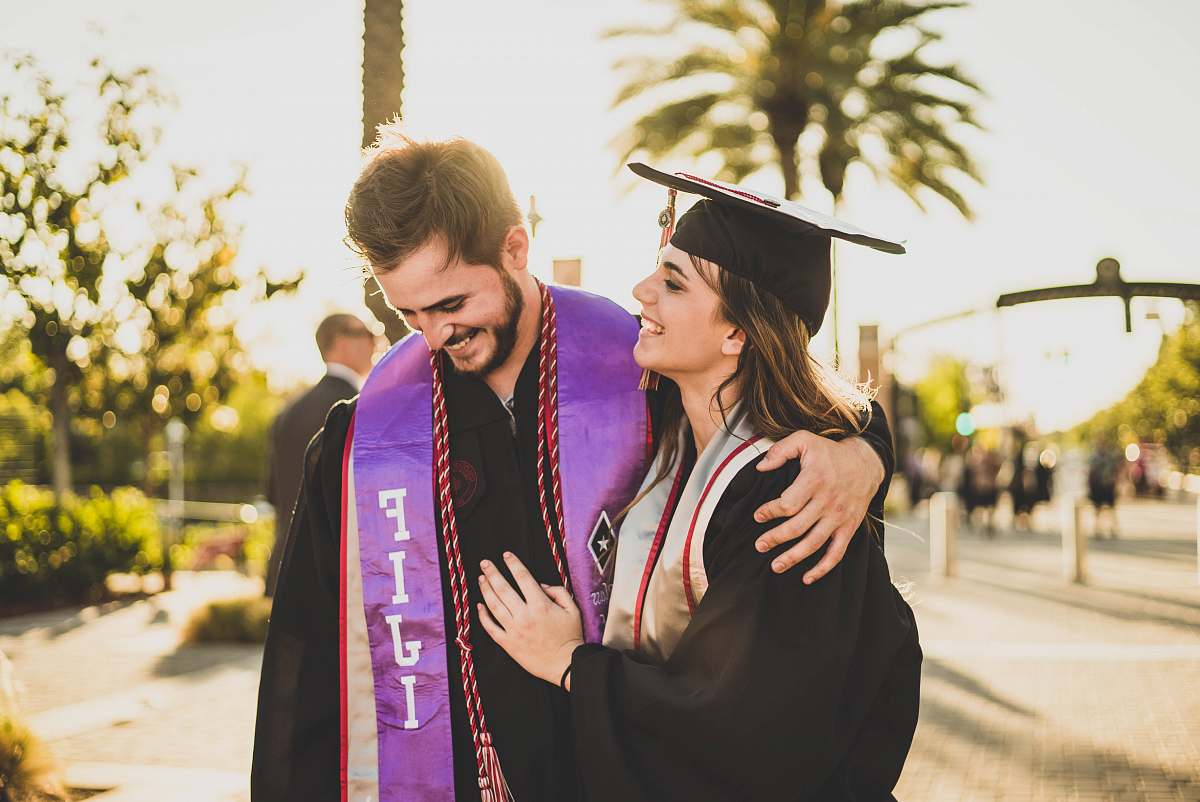 people woman hugging man beside her graduation