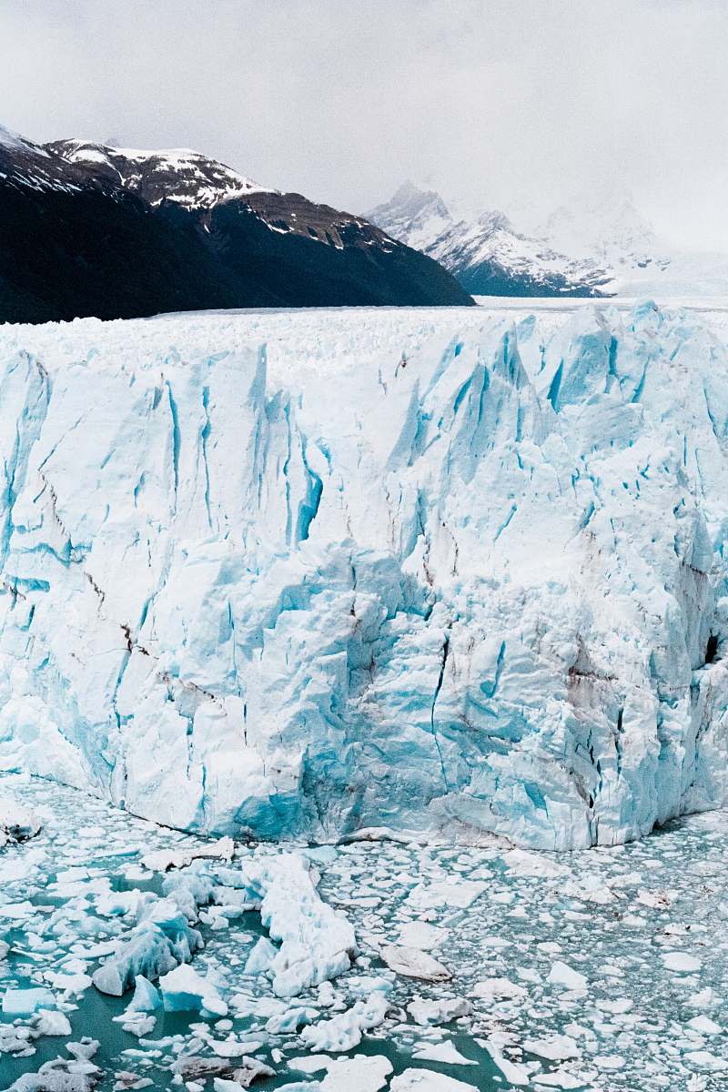 ice iceberg near mountain at daytime snow
