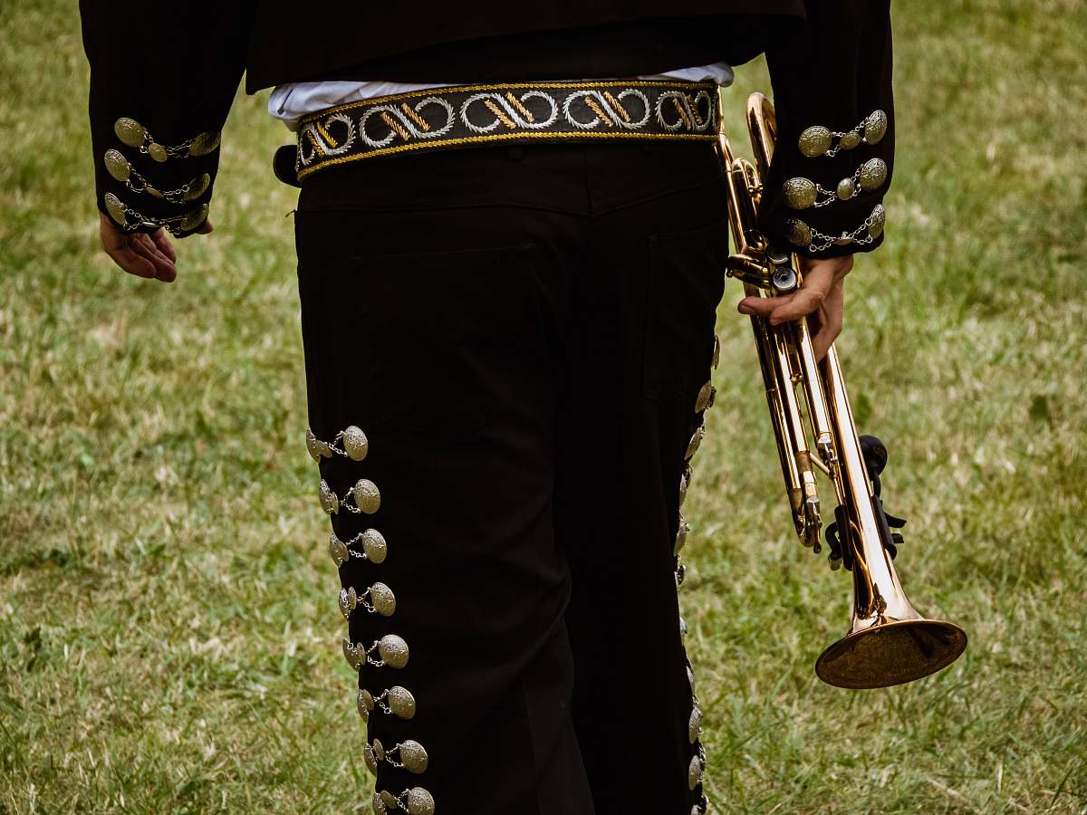 human close-up photography of person holding trombone musical instrument