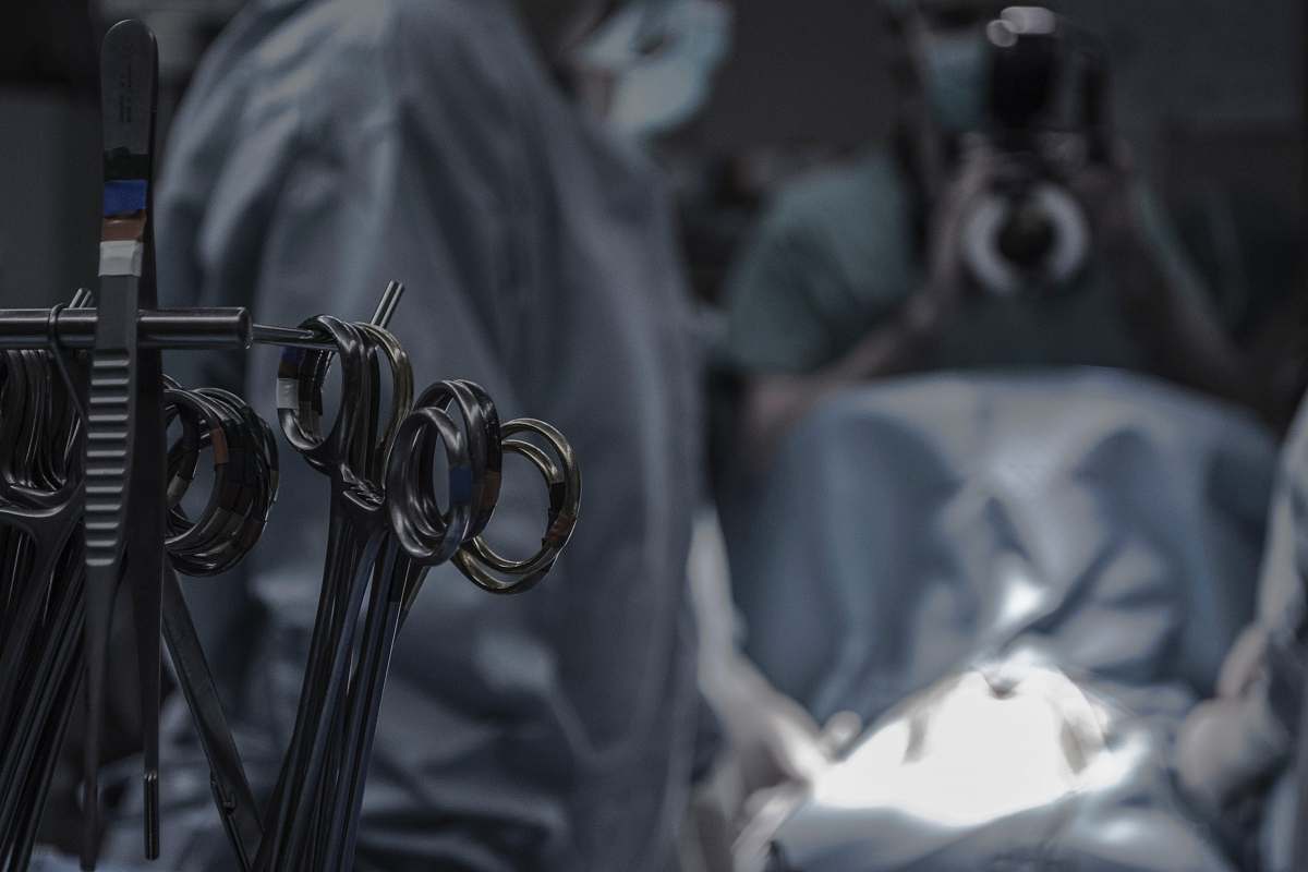  gray surgical scissors near doctors in operating room 