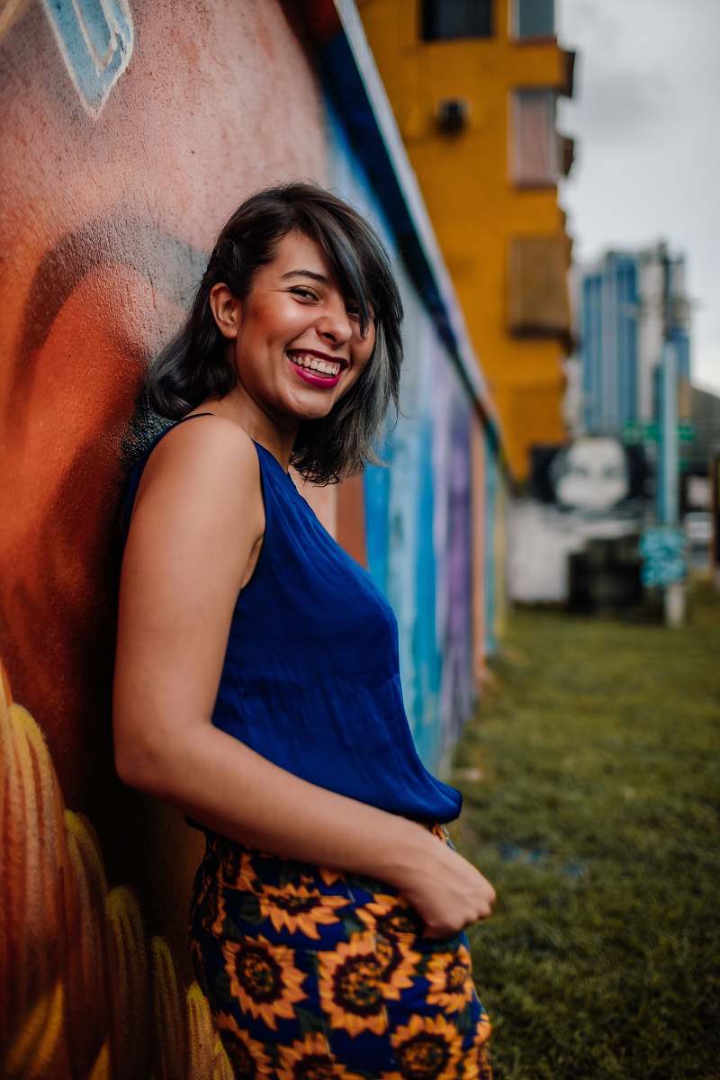 clothing laughing woman leaning on wall fashion