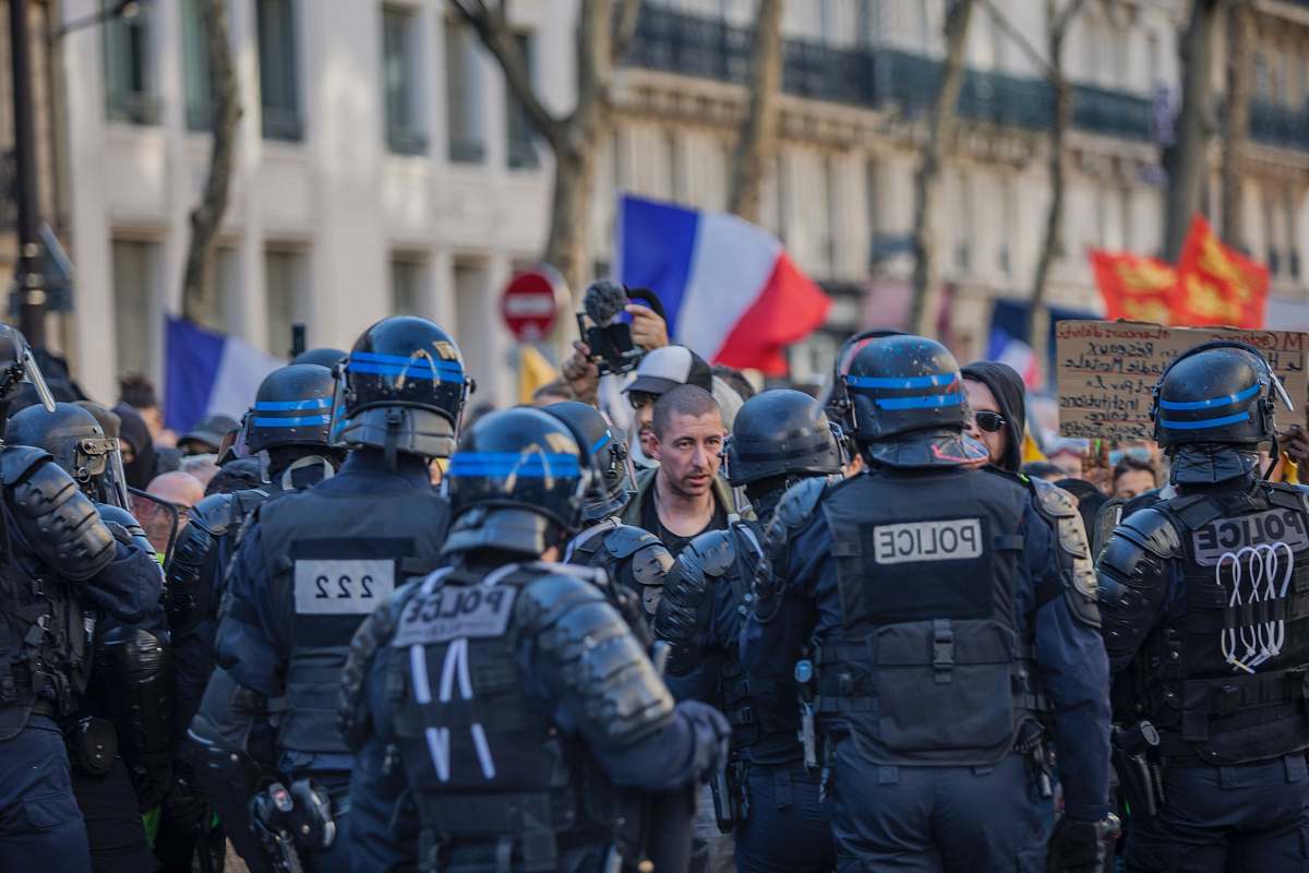 helmet police facing people in road clothing