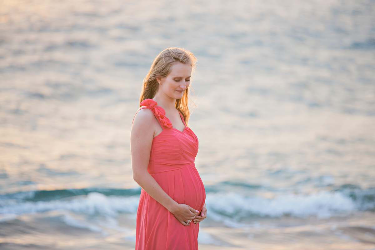 clothing pregnant woman standing on seashort evening dress