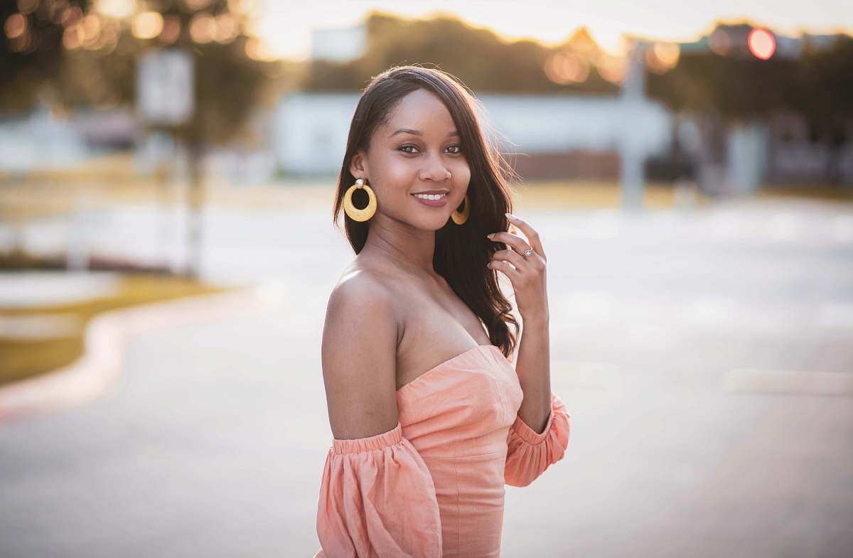 clothing smiling woman in beige tube dress looking over left shoulder robe