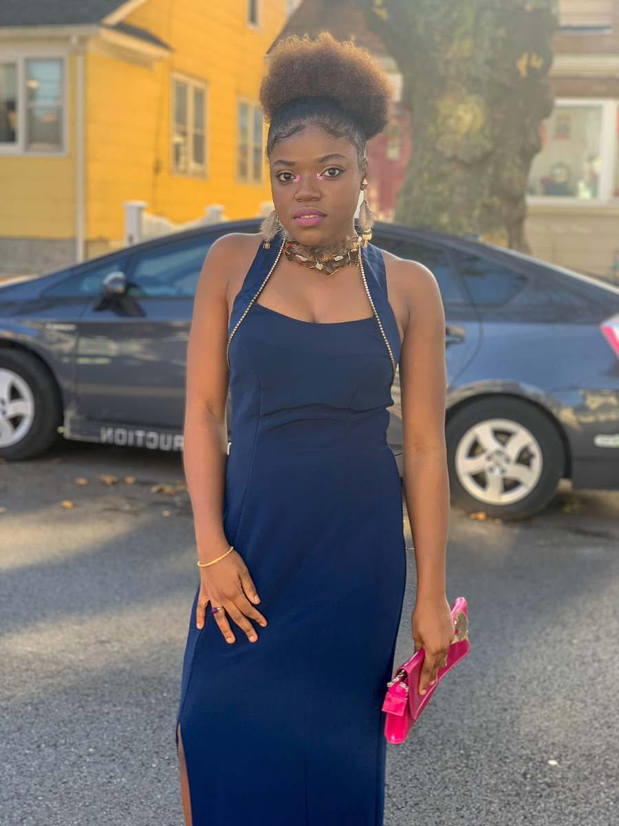 clothing standing woman wearing blue sleeveless dress during daytime evening dress