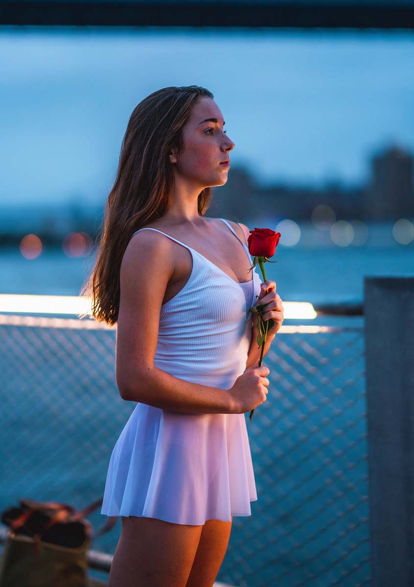 clothing woman holds flower near handrail evening dress