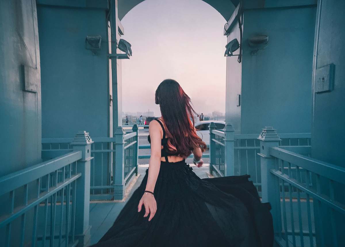 clothing woman in black sheer lace spaghetti strap dress standing indors robe