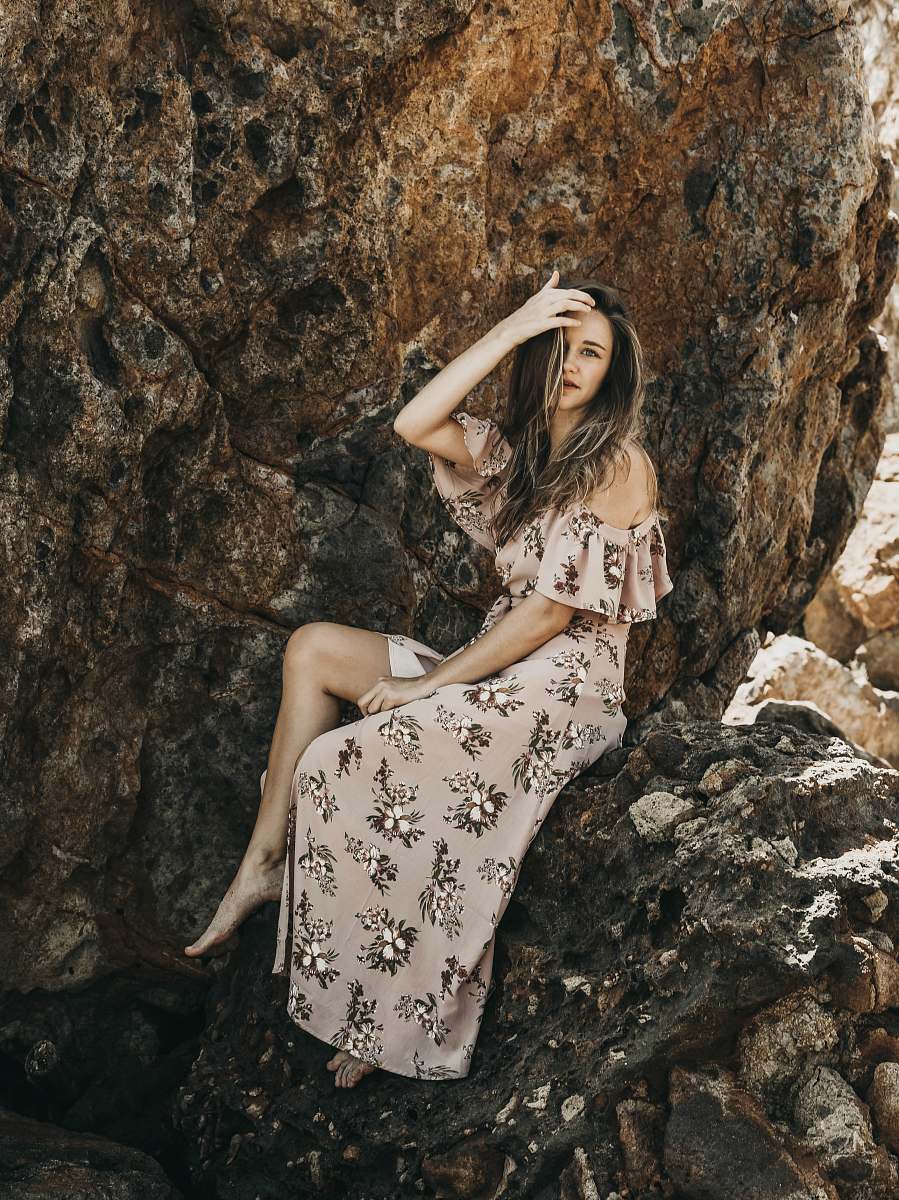 clothing woman in sitting on stone and holding head fashion