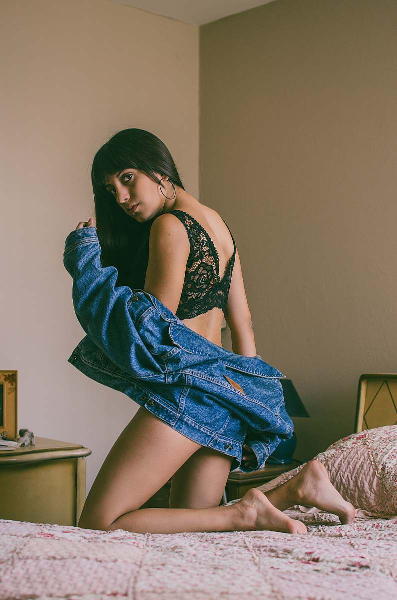 clothing woman on bed wearing black lace brassiere fashion