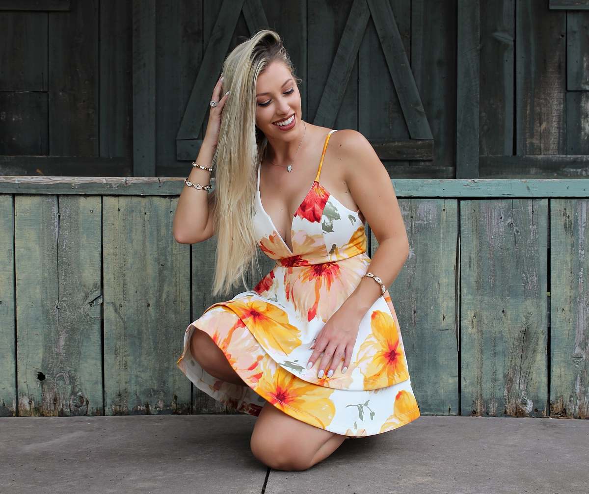 clothing woman sitting beside wall fashion