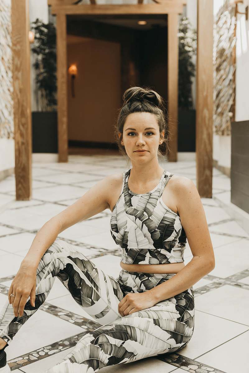 clothing woman sitting on white pathway robe