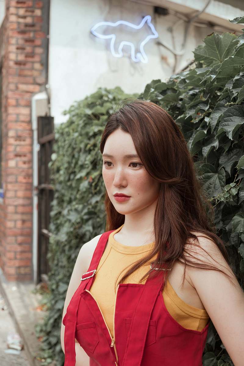 clothing woman standing beside plant fashion