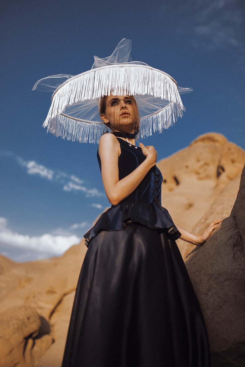 clothing woman standing beside rock evening dress