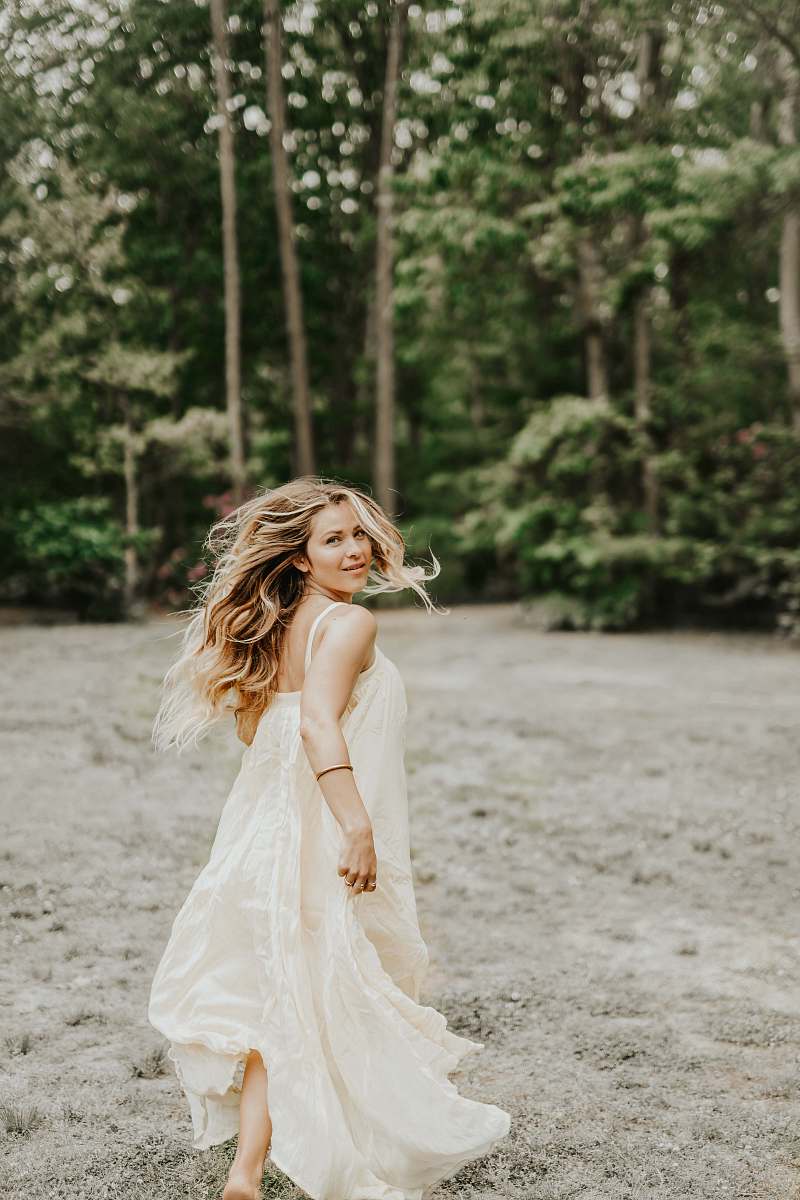 clothing woman wearing dress beside tree gown