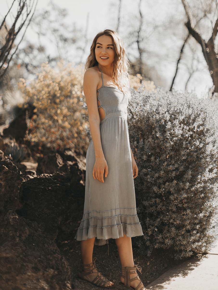 clothing woman wearing gray halter dress near green plant evening dress