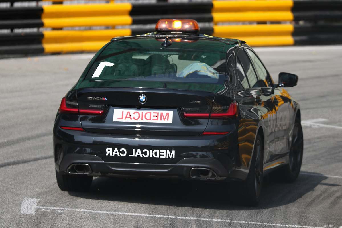 transportation blue BMW car facing backward on a race track vehicle