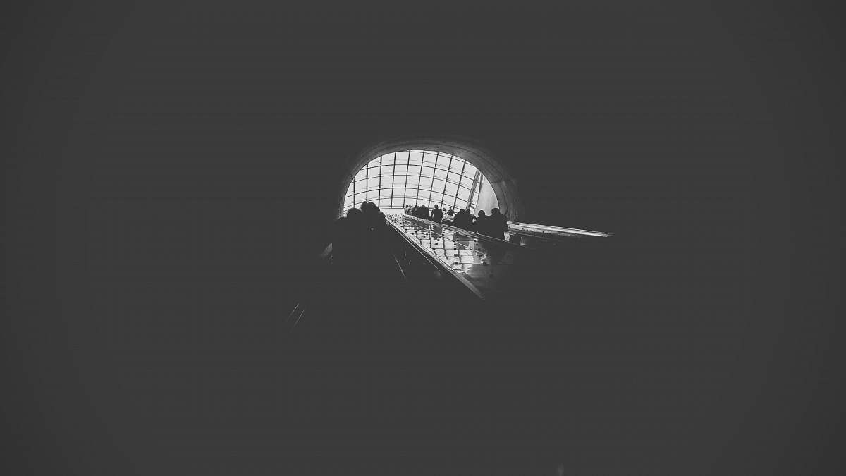 grey greyscale photography of people inside cave medical center station