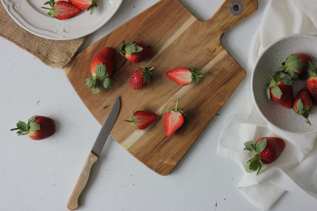 knife sliced strawberries on cutting board weapon
