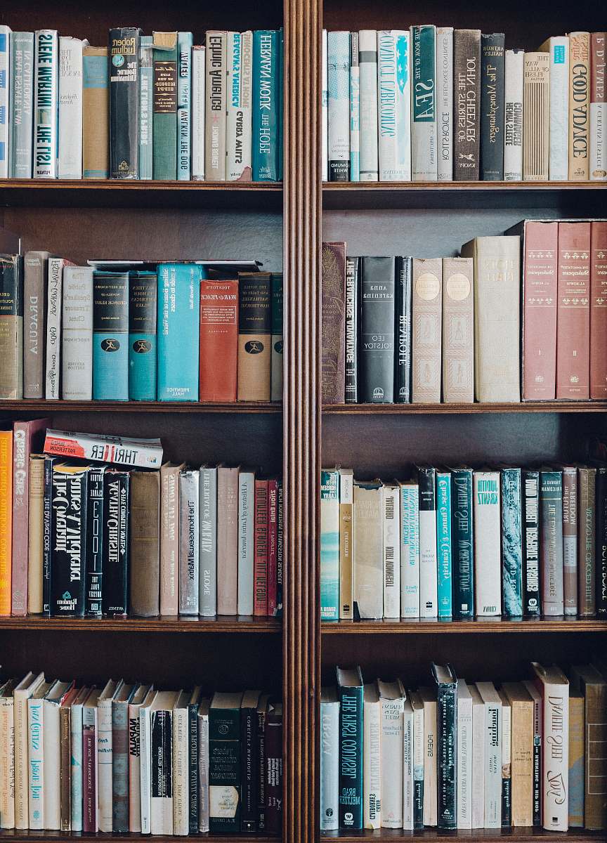 shelf assorted-title book in bookcase bookcase