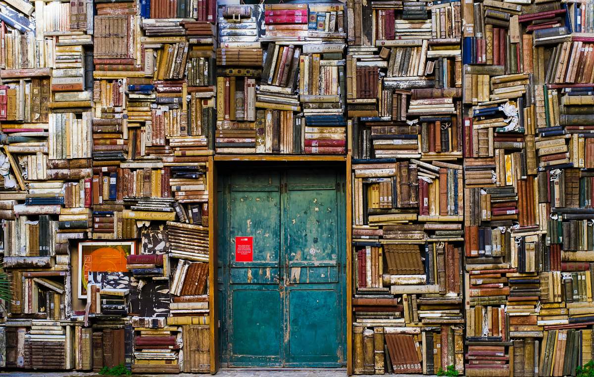 Books Blue Wooden Door Surrounded By Book Covered Wall Door Image Free ...