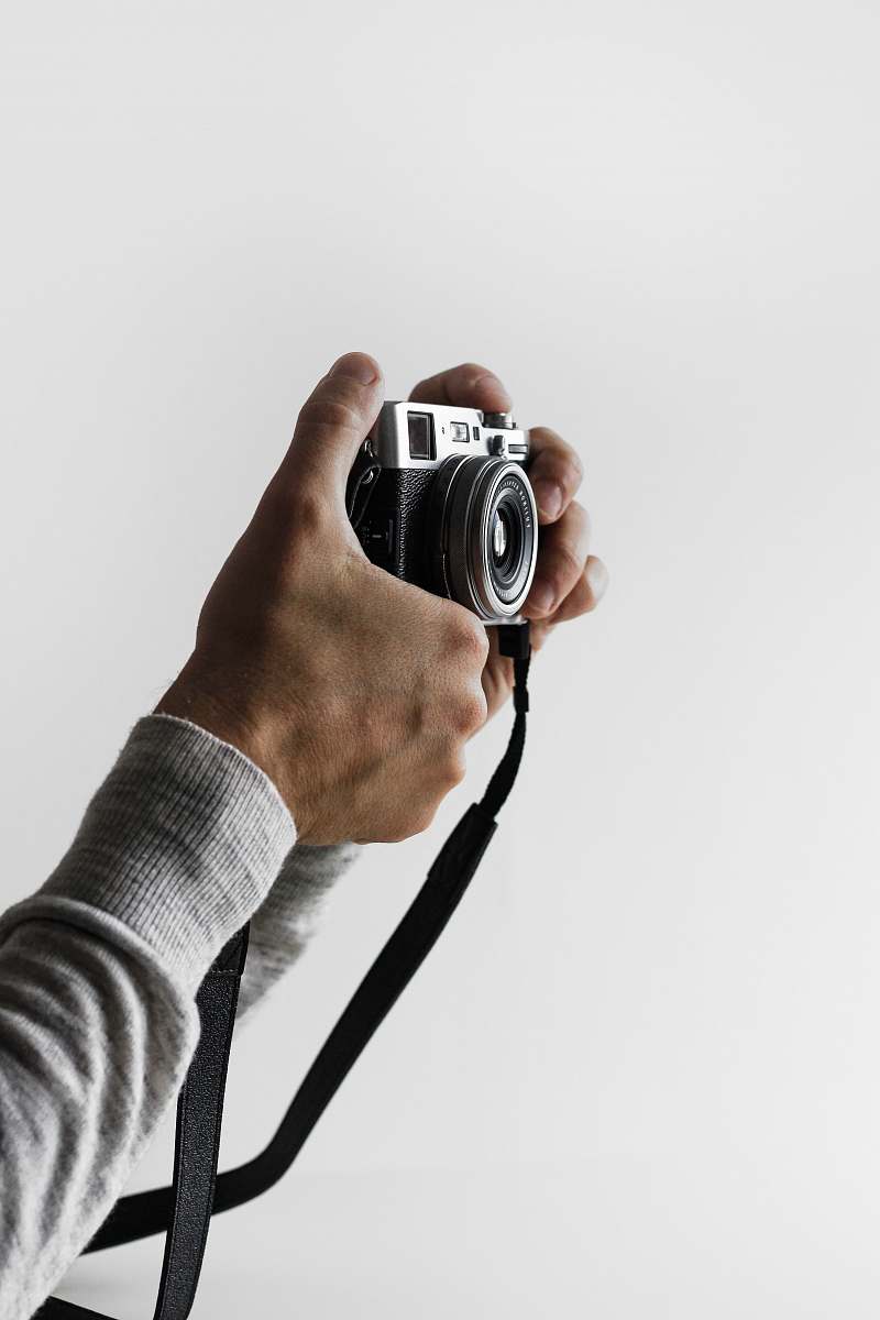 human person holding gray and black camera person