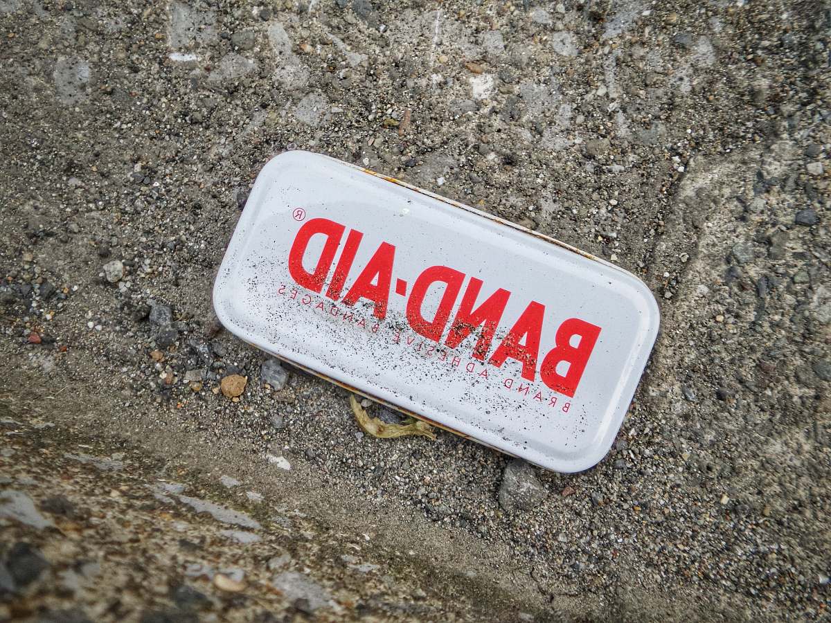 aluminium rectangular white case on gray surface tin