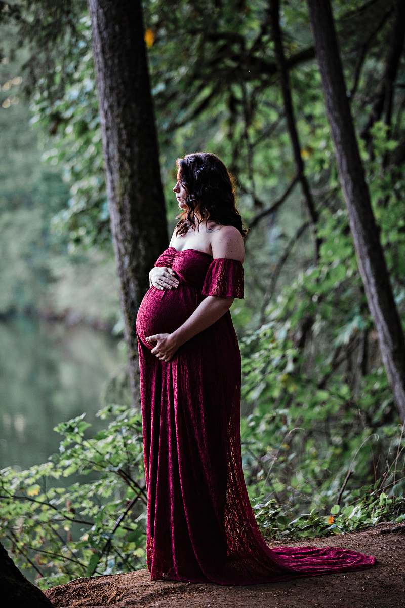 apparel pregnant woman standing near trees during day gown