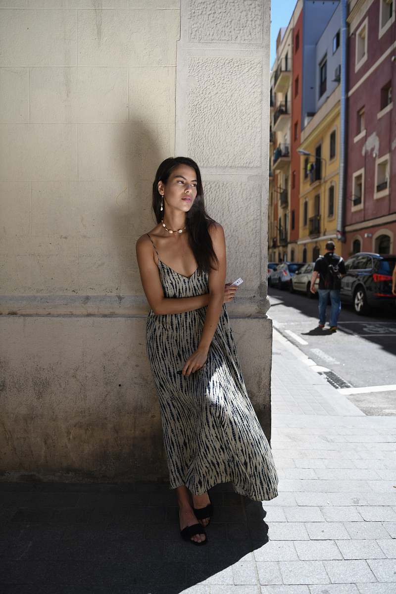 apparel woman leans on wall fashion