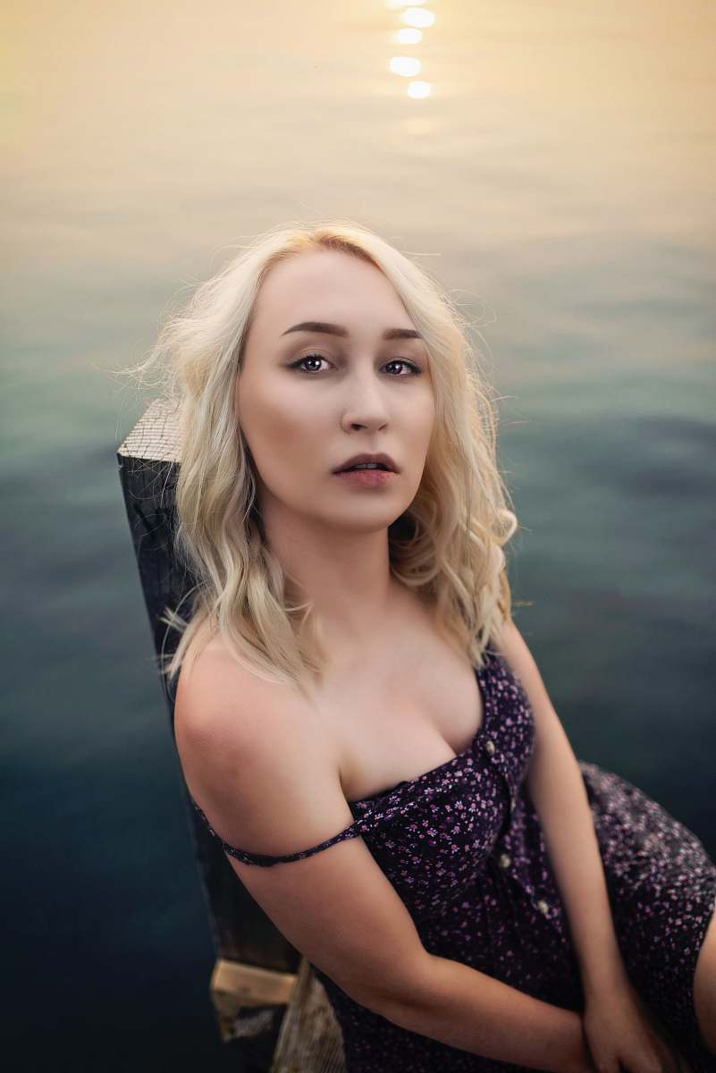 apparel woman sitting on wooden dock fashion