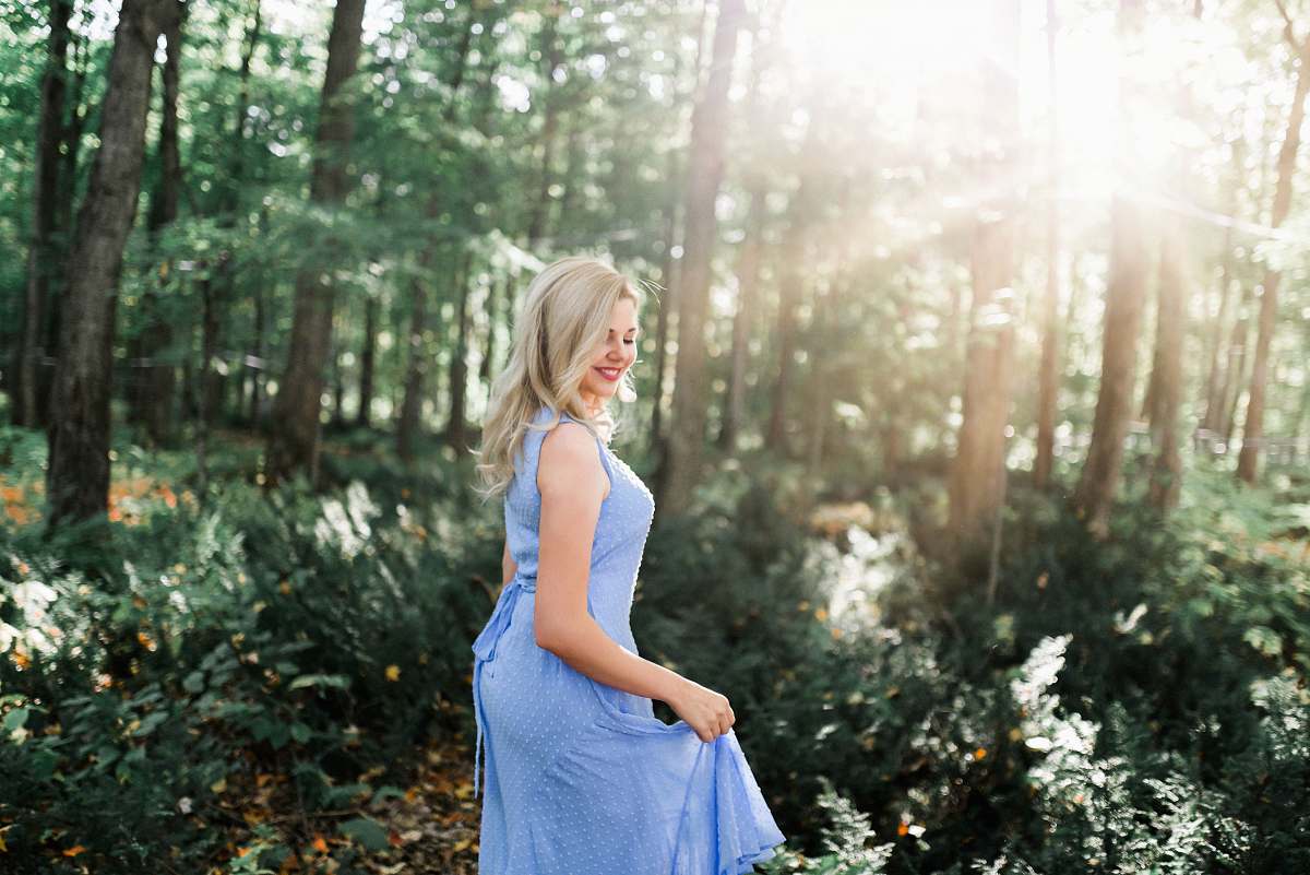 apparel woman smiling and standing in the forest fashion