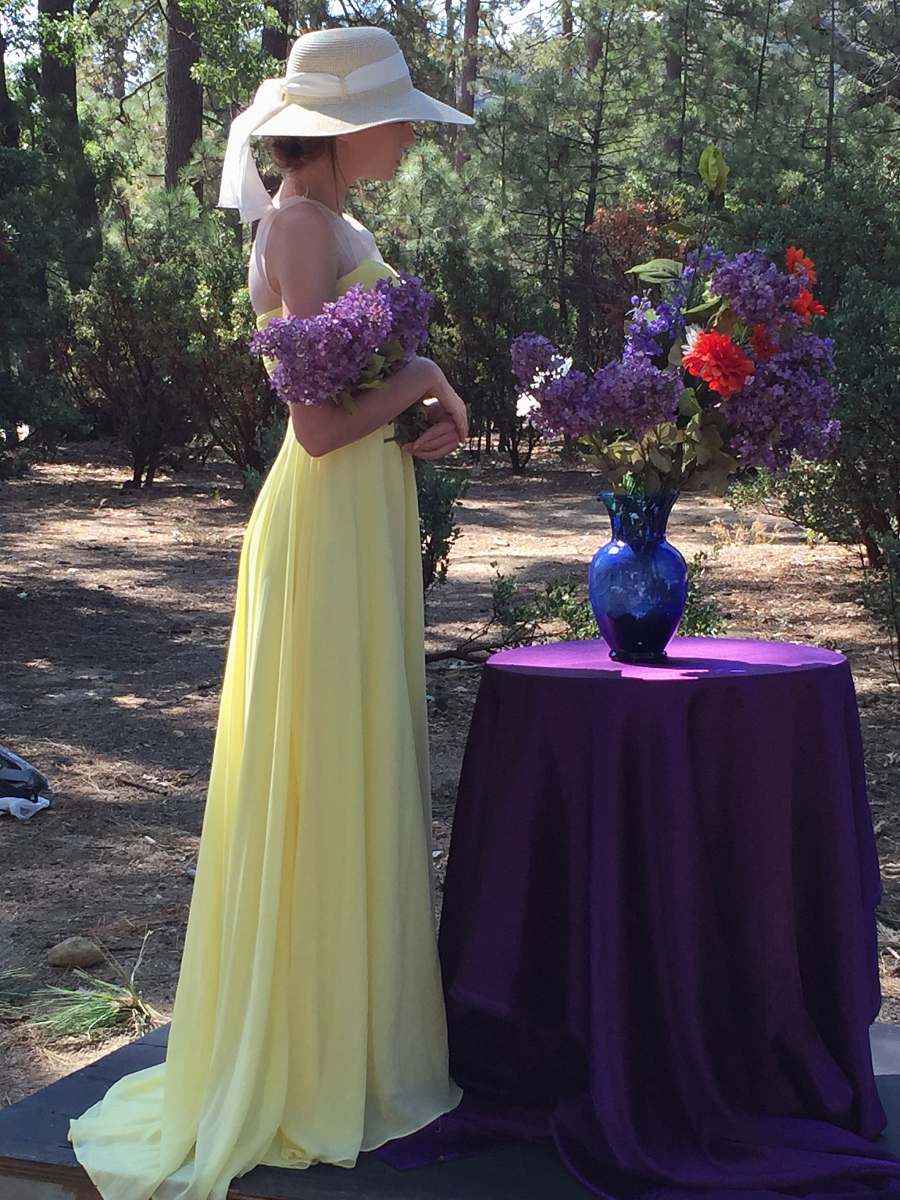 apparel woman standing in front of flower vase fashion