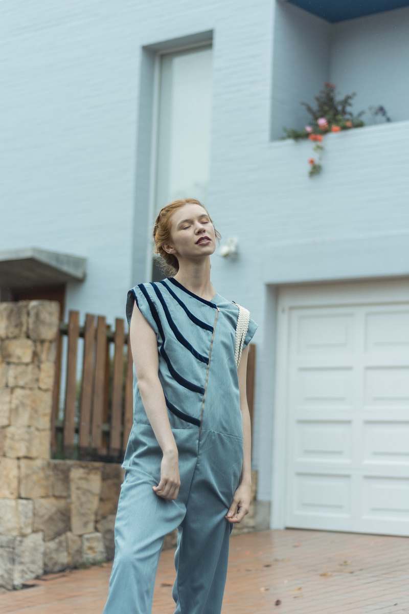apparel woman standing near house fashion