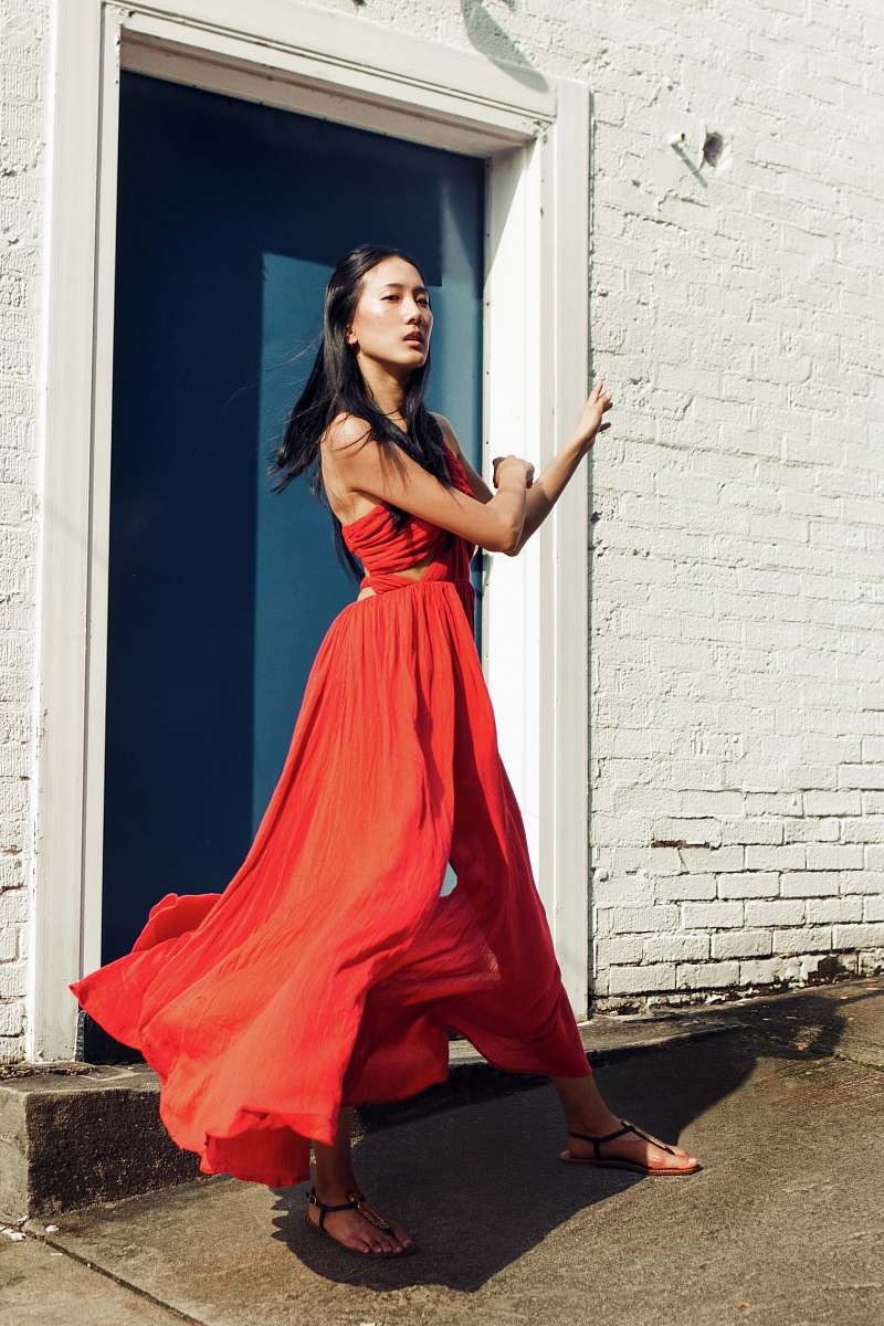 apparel woman wearing red sleeveless dress near blue door fashion