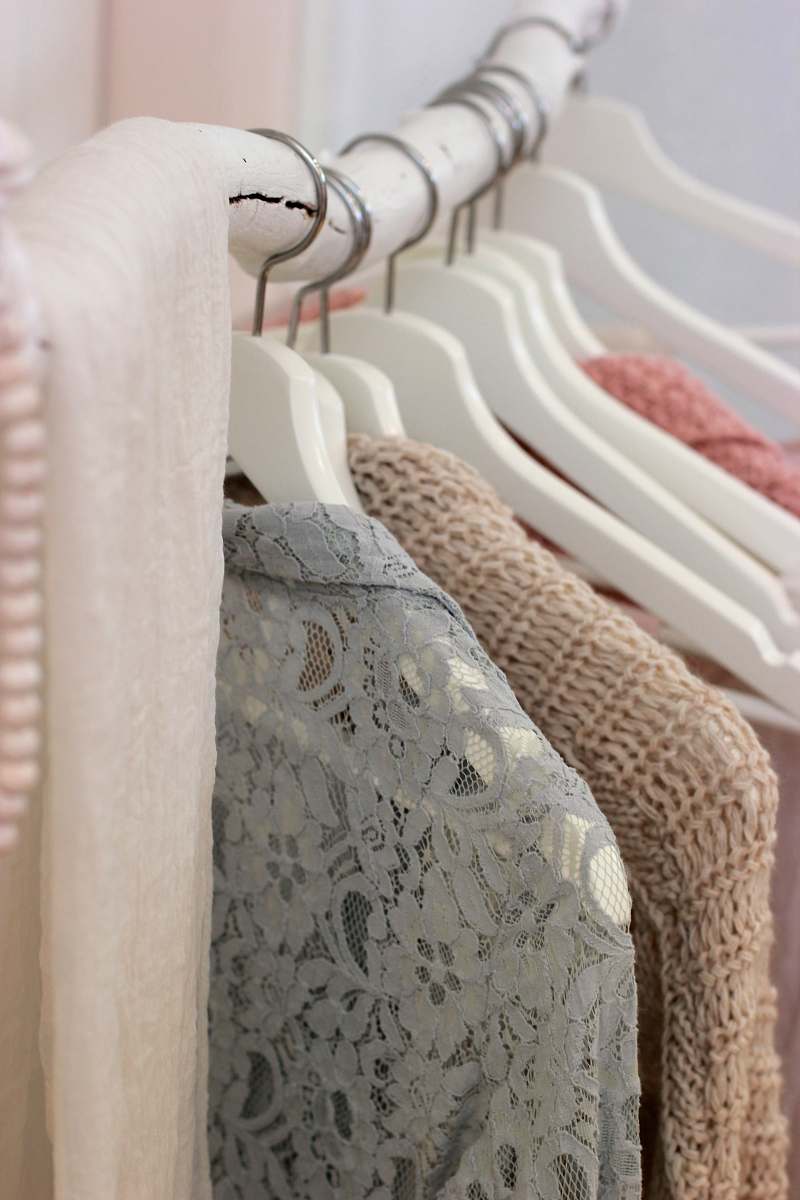 clothes clothes hanging on white rack closet