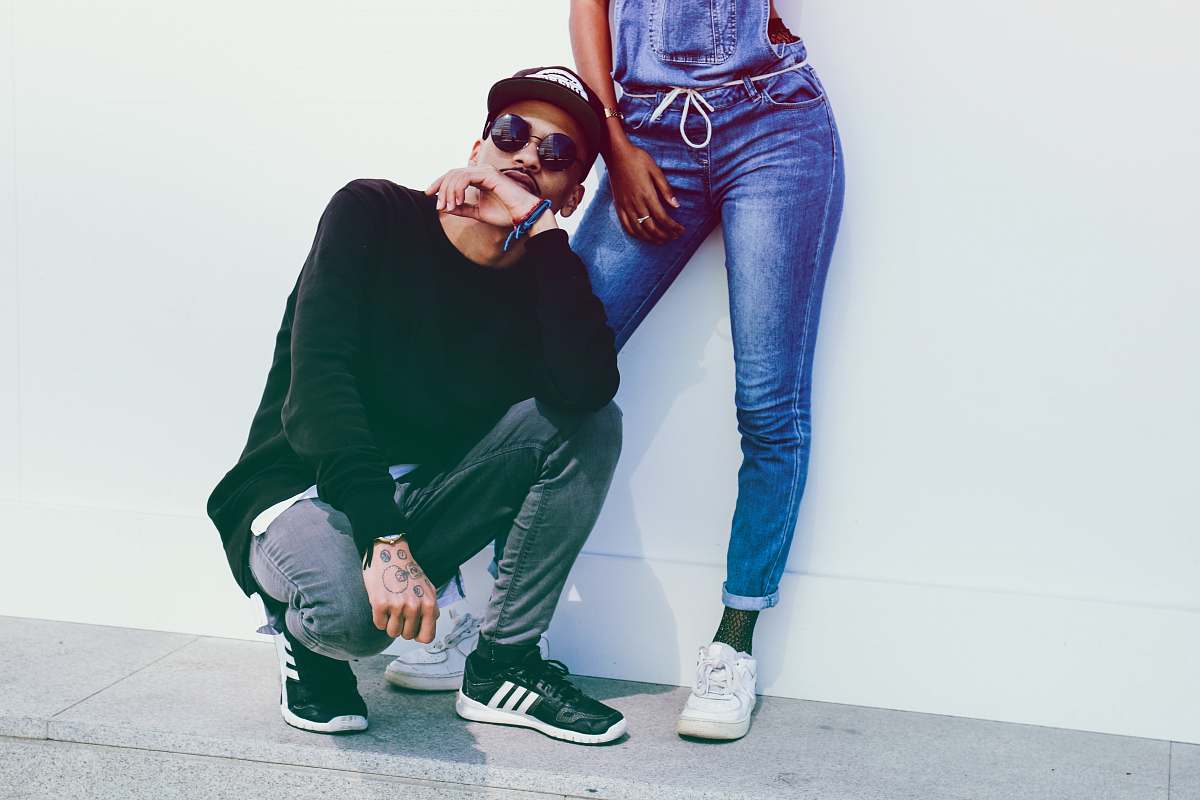 person man sitting beside person wearing overalls people