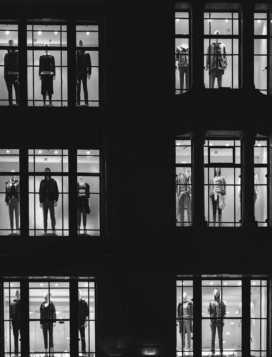 black-and-white mannequin in front of windows black
