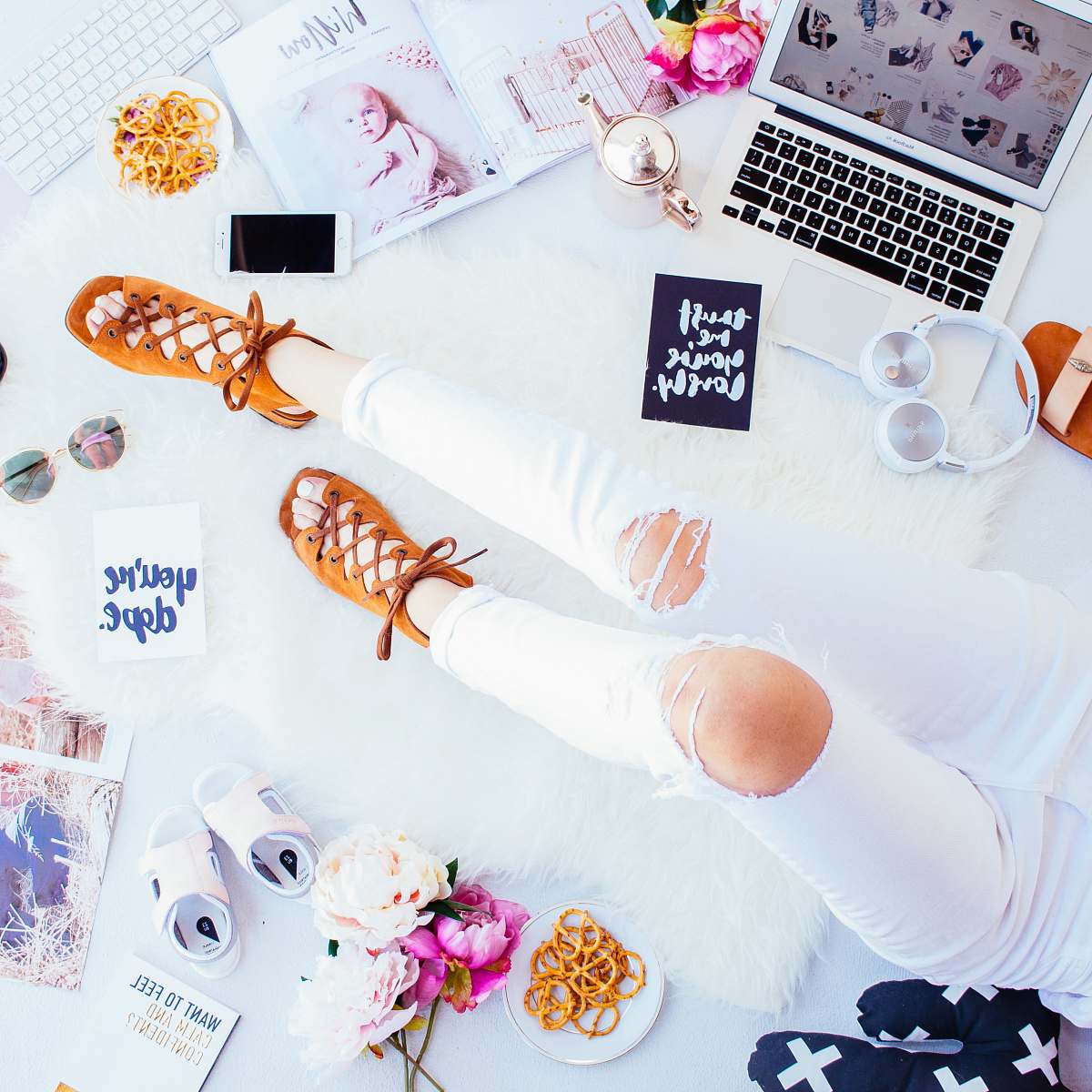 flatlay person wearing distressed white pants and brown suede lace-up sandals work