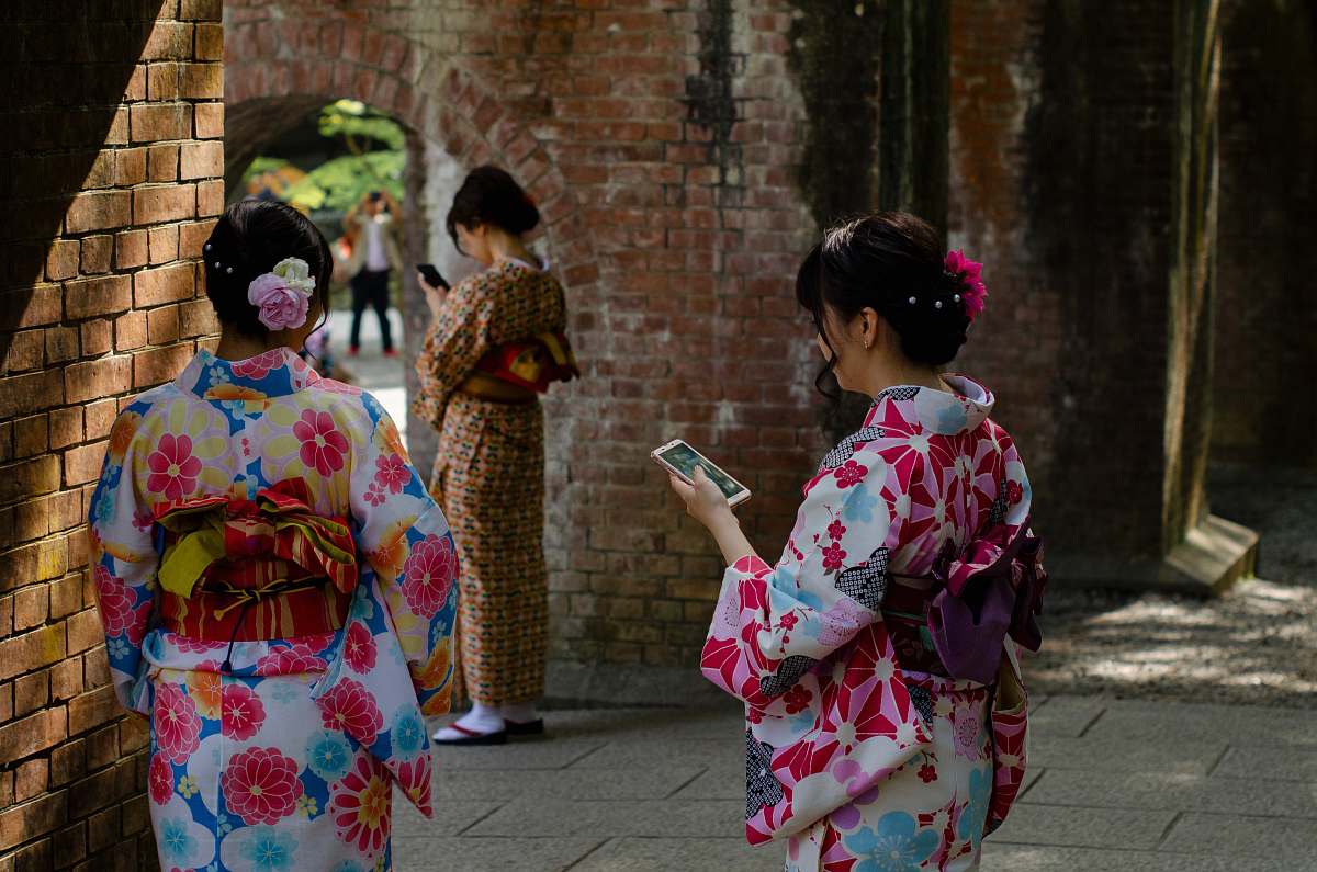 apparel three women wearing kimono dresses during daytime clothing