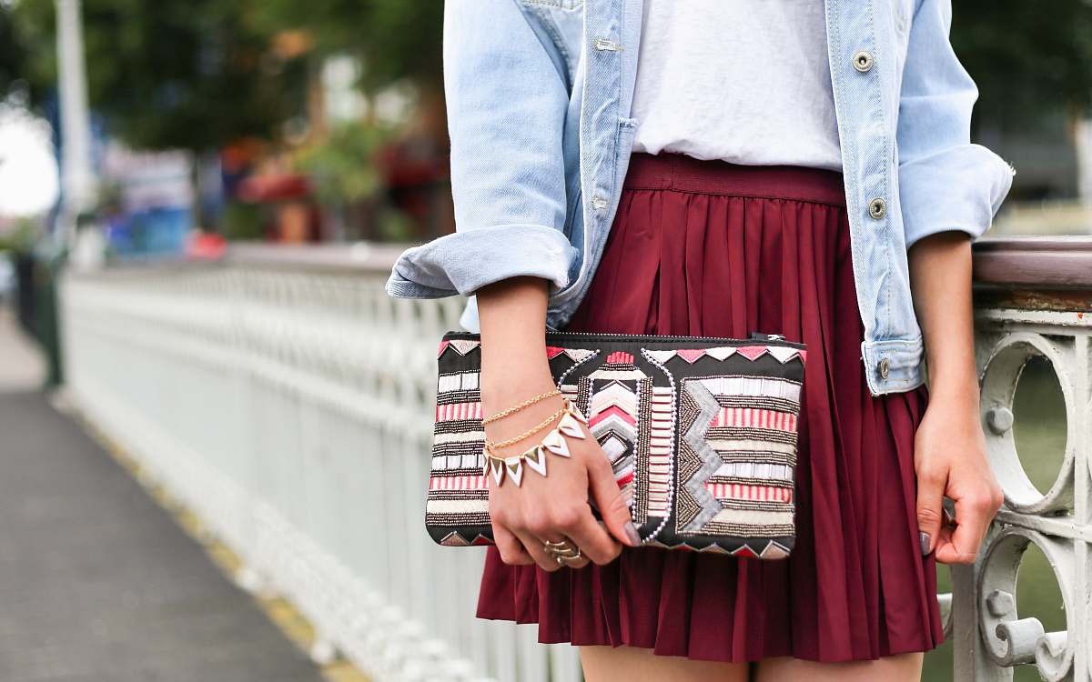 woman woman holding clutch bag standing beside white bridge style