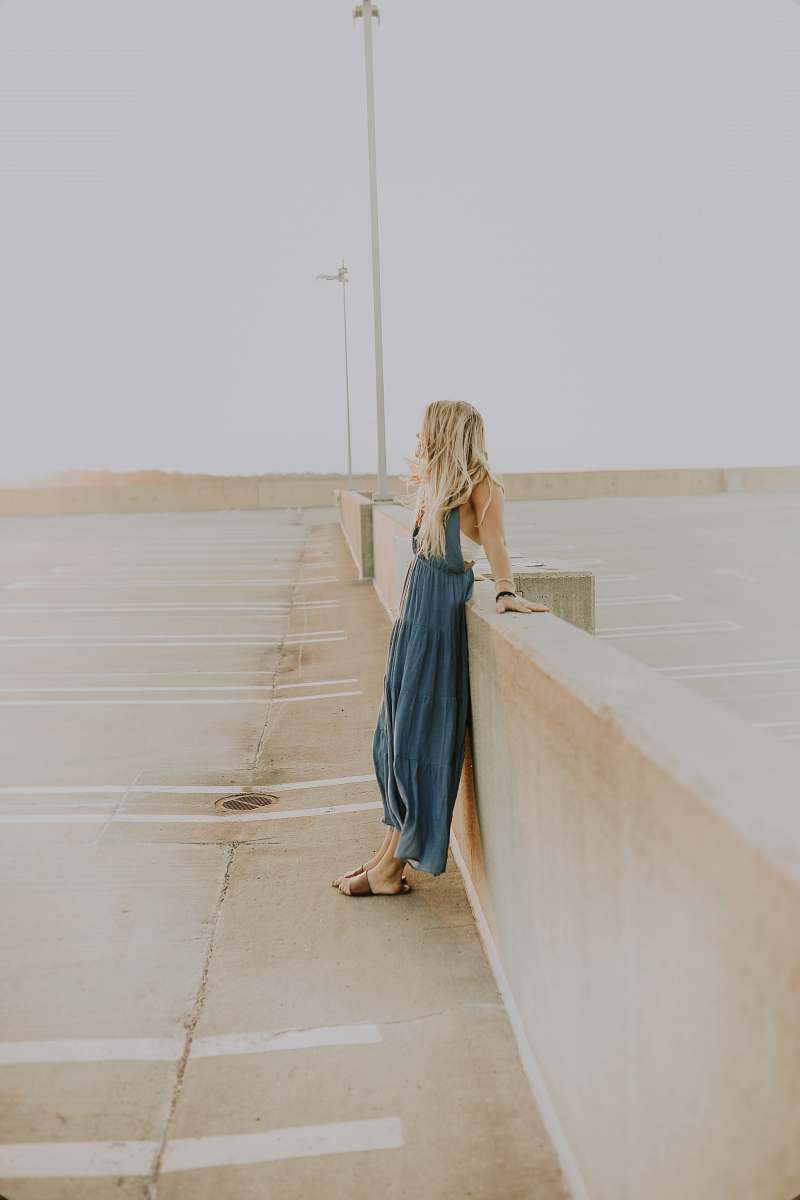 clothing woman leaning on wall apparel