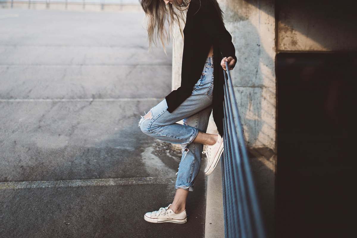 people woman standing beside fence human