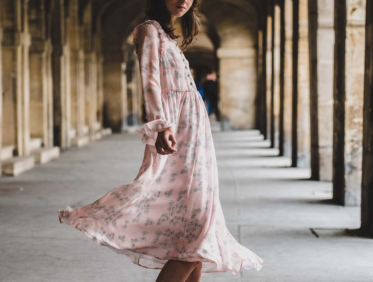 woman woman wearing pink long-sleeved dress standing inside building female